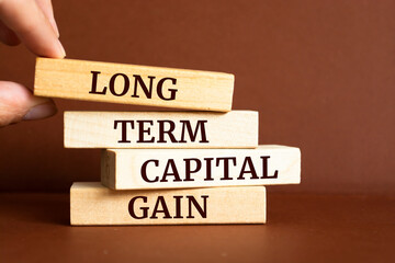 Wooden blocks with words 'Long term capital gain'.