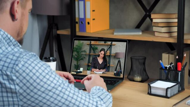 Online business meeting. Businessman in home office talk top manager remote video call webcam chat laptop. Woman employee in computer screen writes tasks in notebook listen distance director company