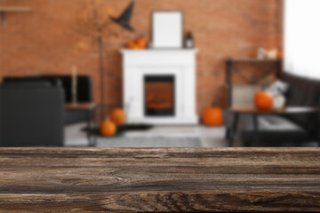 Empty wooden table in living room decorated for Halloween party