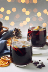 Glass of delicious mulled wine on light table