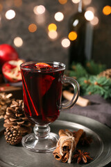 Glass cup of tasty mulled wine on table