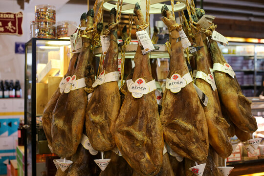 Pig's legs with black hoof in shop. Spanish jamon market. Madrid, Spain - July 2019