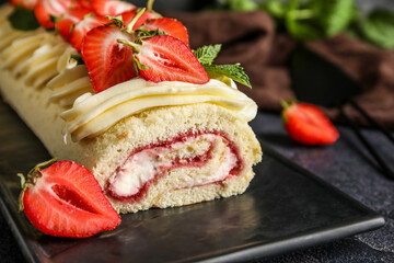 Board with tasty strawberry roll cake, closeup