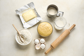 Set of ingredients for baking with rolling pin on light background