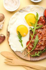 Plate with fried eggs and bacon on color background, closeup
