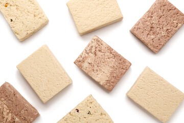 Pieces of tasty sesame halva isolated on white background