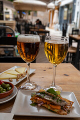 Lunch with cold beer in Spanish outdoor cafe, different tapas, fish, green olives and Spanish cheese manchego with nuts, Malaga, Andalusia