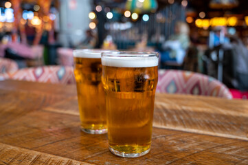 Fresh draught lager beer is glass served in indoor cafe