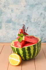 Composition with juicy watermelon on color wooden table