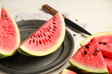 Plate with slices of watermelon on white background, closeup