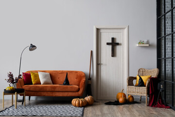 Interior of living room decorated for Halloween with sofa and armchair