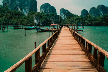 A wooden bridge over blue water in Asia