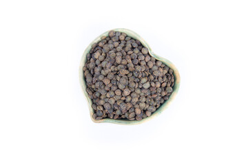 Puy or French Green Lentils in a Heart Shaped Blue Pottery Bowl Isolated on White