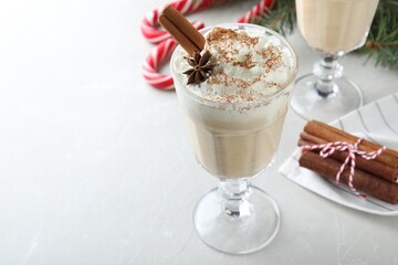 Delicious Christmas cocktail with liqueur on white table. Space for text