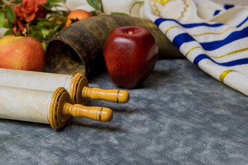Orthodox traditional holiday New Year symbols of Rosh Hashanah display a shofar, apples,...