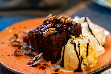 Piece of brownie chocolate cake with vanilla ice cream