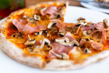 Eating of fresh baked pizza dish in italian pizzeria restaurant