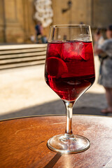 Glass of cold sangria wine served outdoor in bar with view on old street in San Sebastian, Basque Country, Spain
