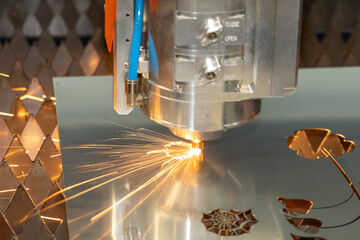 Laser cutting steel. Automatic laser cutting machine cuts shaped parts out of stainless steel. Sparks from laser cutting metal. Metalworking at the factory