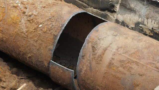 District heating rusted pipeline with steel tube installed in underground tunnel. Insulated steel pipe in deep trench