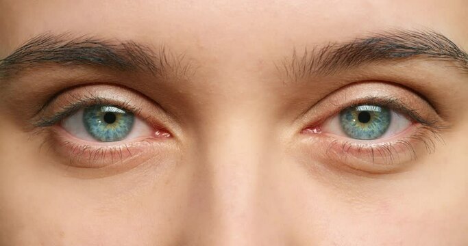 Blue eyes, eyesight and vision of beauty woman with dilated pupils from optometry test, drug or medication for wellness and healthcare. Portrait and macro or zoom of a human feeling awake and aware