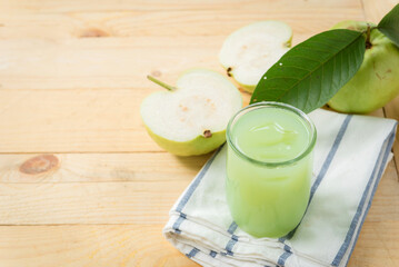 Guava juice, Guava water with Guava fruit, high Vitamin C, green drink, on wood background