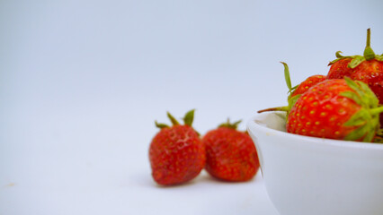Fresh ripe delicious strawberries in a white bowl on a white background. isolated background