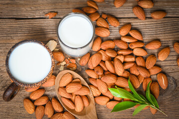 Almond milk and Almonds nuts wooden background, Delicious sweet almonds on table, roasted almond nut for healthy food and snack
