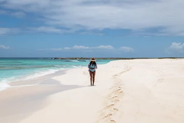 Foto op Canvas Cayo de Agua (Los Roques Archipelago), Venezuela, 07.30.2022: young woman walking on the white beach in the caribbean sea. © Giongi63