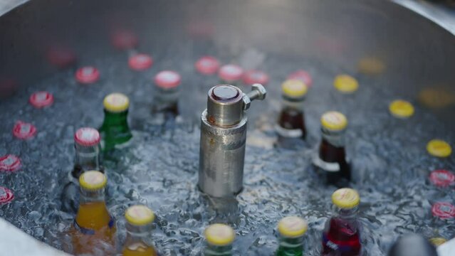 A close up shot of soft drink is cooling in a rotational machine in Thailand night market