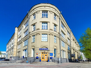 Facade of Old main post office building, historical house in sunny summer day. Neoclassical building, architectural monument, architect Kryachkov. Novosibirsk, Russia 10 may 2022