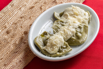 Italian pasta, spinach tortelloni with white sauce