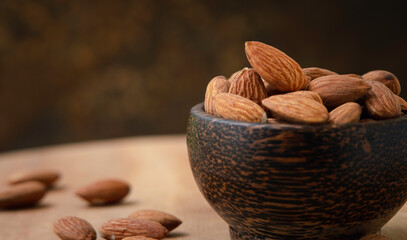 close-up almonds in a wooden bowl