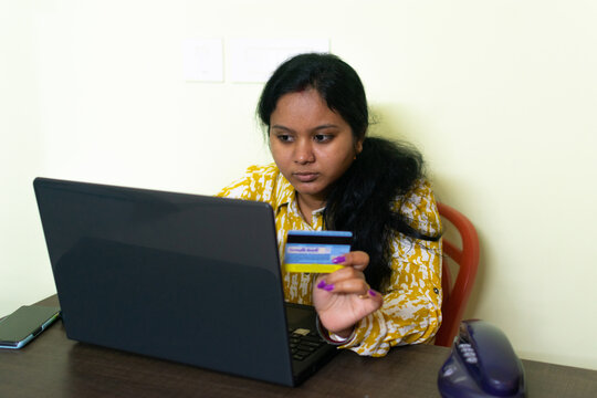 Cropped image of woman inputting card information while shopping online