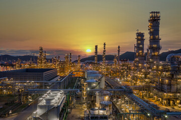 Fototapeta premium Oil and gas refinery plant form industry zone at night, Aerial view oil and gas Industrial petrochemical fuel power and energy.