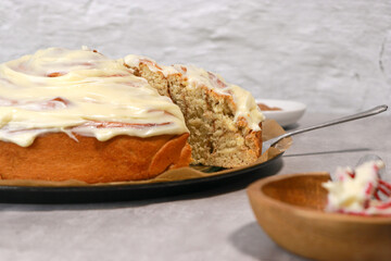 giant cinnamon roll with buttercream frosting,, grey marble table