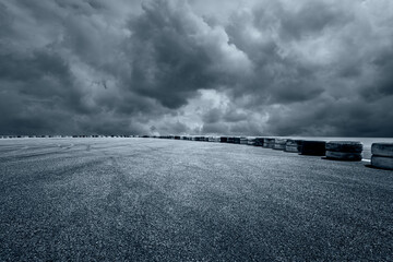 Asphalt road and sky dark clouds nature background © ABCDstock