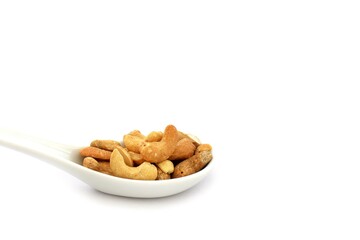 Cashew nuts on the white ceramic spoon