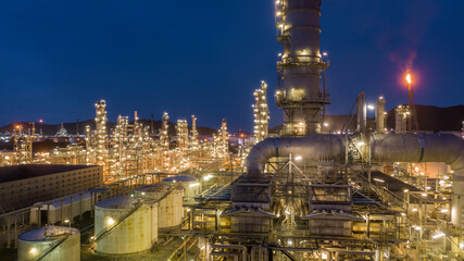 Oil and gas refinery plant form industry zone at night, Aerial view oil and gas Industrial petrochemical fuel power and energy.