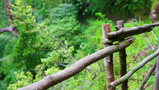 A Fence Made From Wood That Divide Between Footpath and Cliff