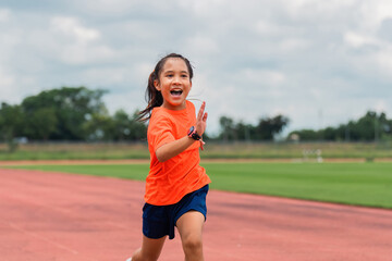 Fototapeta premium Girl practicing on her running technique in the track