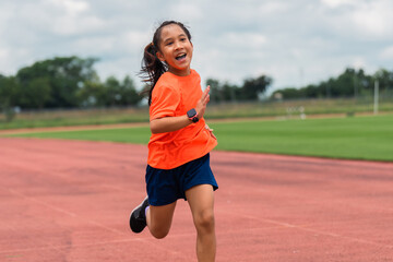 Girl practicing on her running technique in the track