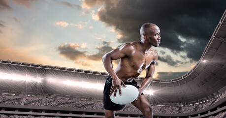 Composition of shirtless male rugby player holding rugby ball over sports stadium