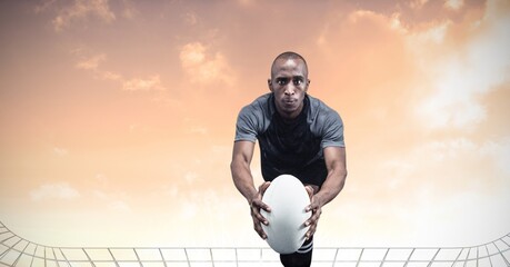 Composition of male rugby player holding rugby ball over sports stadium