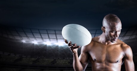 Composition of shirtless male rugby player holding rugby ball over sports stadium