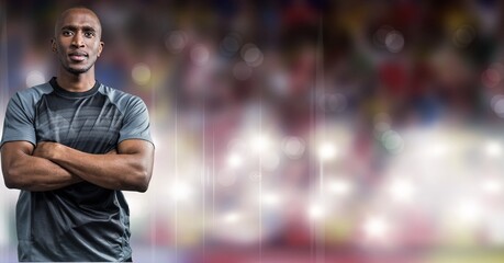 Composition of male rugby player with arms crossed over sports stadium