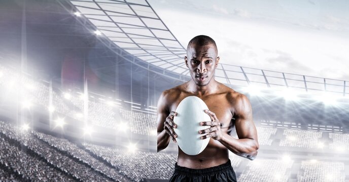 Composition of shirtless male rugby player holding rugby ball over sports stadium