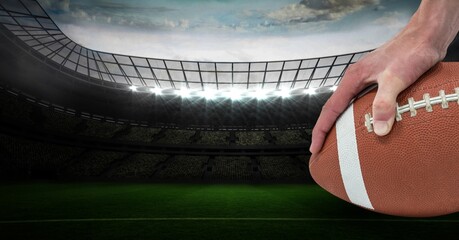 Composition of male rugby player holding rugby ball over sports stadium