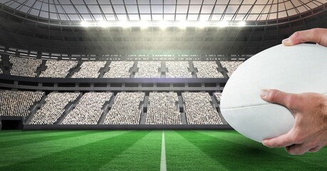 Composition of male rugby player holding rugby ball over sports stadium