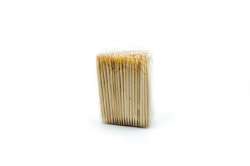 toothpick made of wood wrapped in plastic isolated on a white